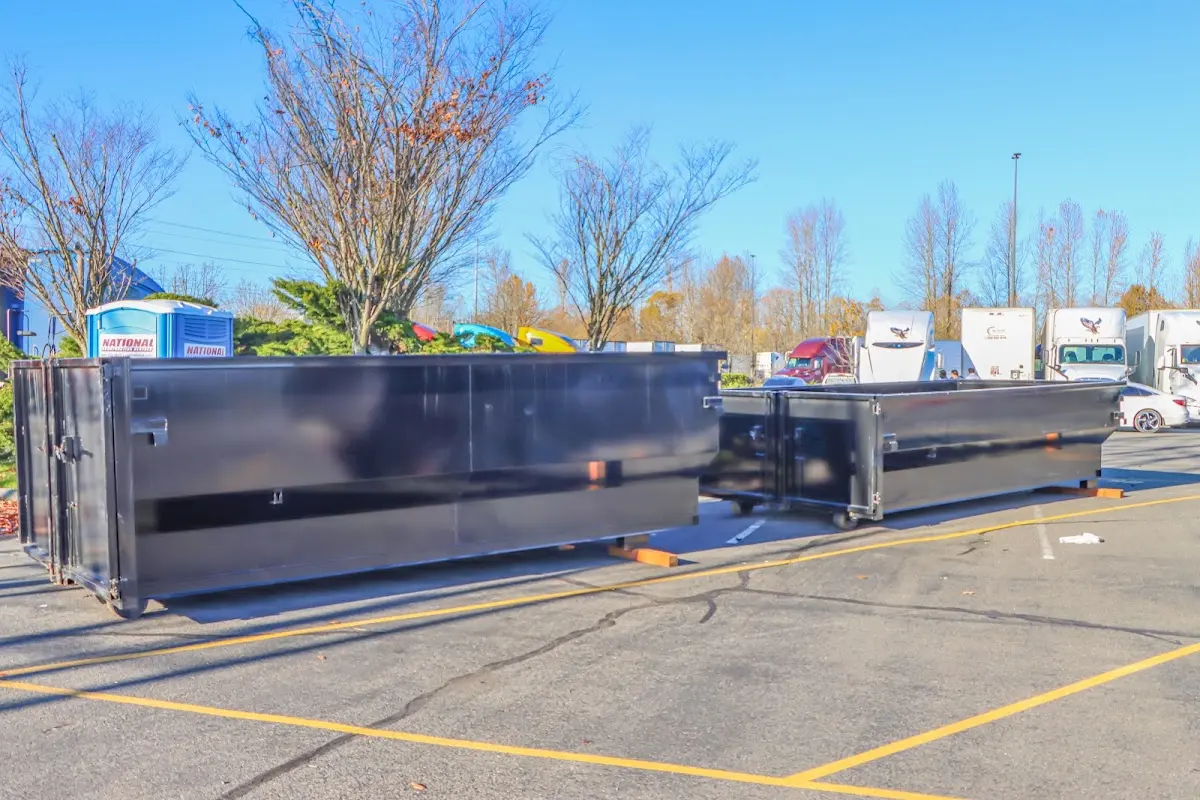 Professional dumpster rental service with roll-off container on residential driveway in Middleton